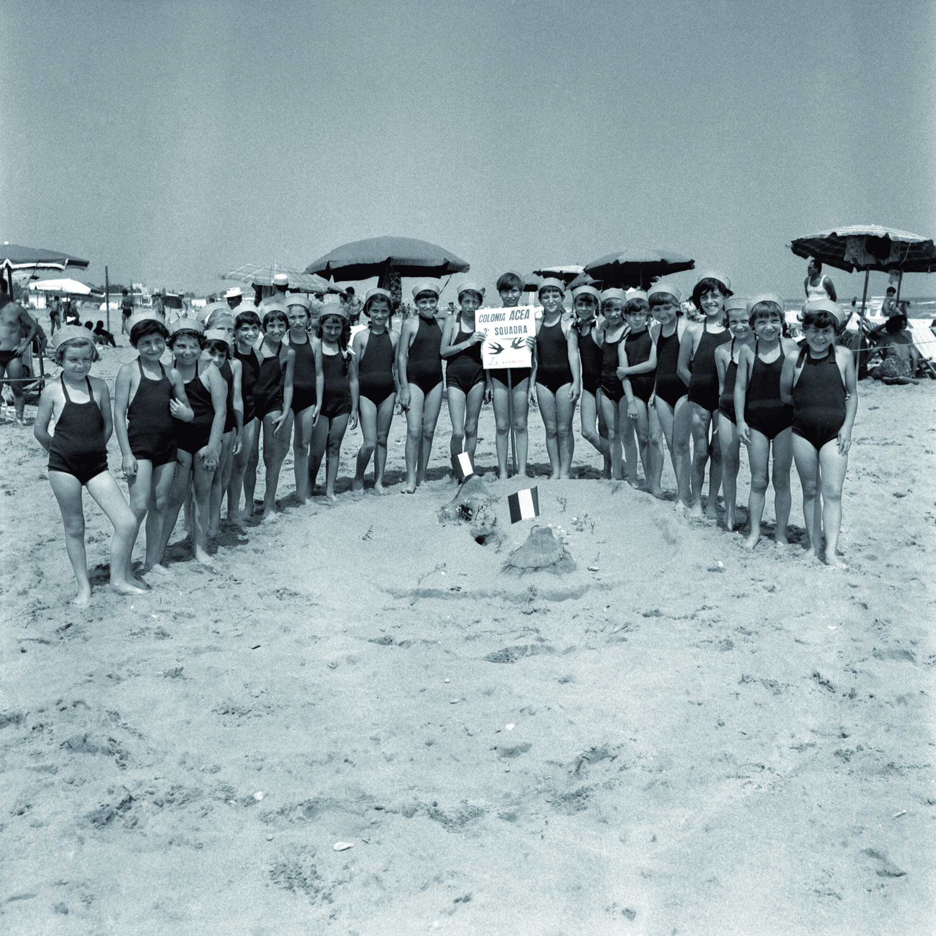black and white photo of some costumed women posing for a group photo
