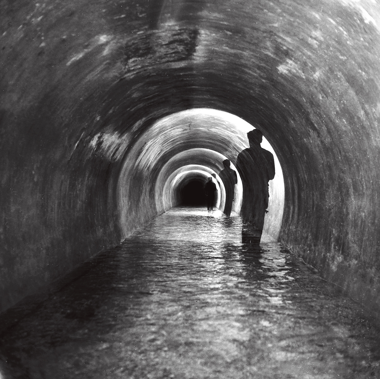 black and white photo of the Peschiera aqueduct tunnel